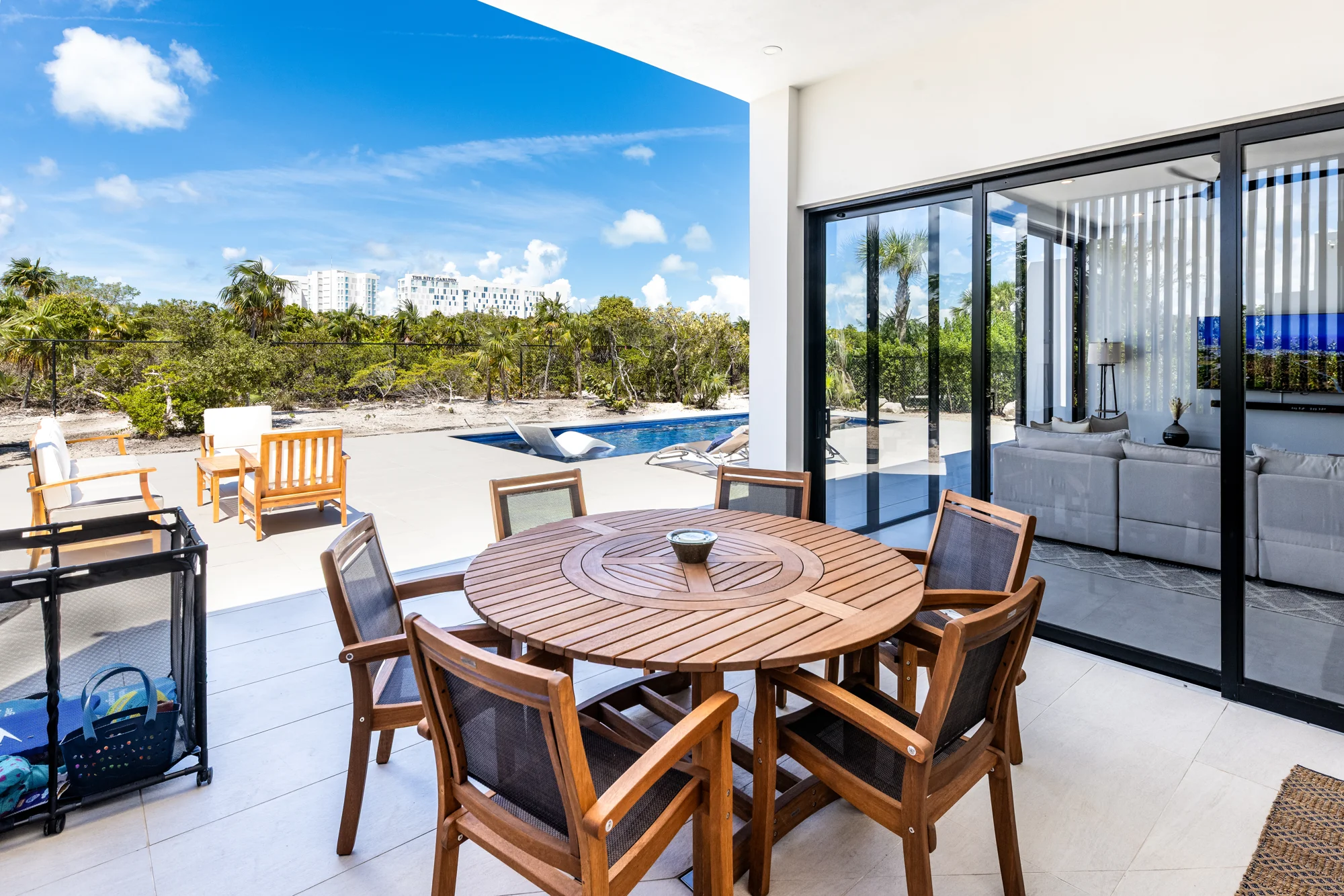 Covered outdoor dining patio beside the private swimming pool